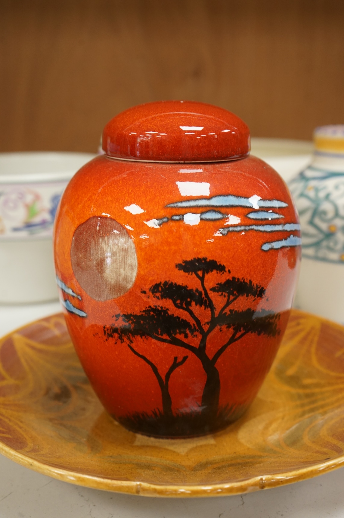 A collection of eight Poole pottery pieces to include vases, bowls and a jar and cover, largest 28cm in diameter